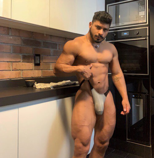 That’s One BIG Sausage He’s Got There and Larger Than the the One That’s  Baking in the Oven.