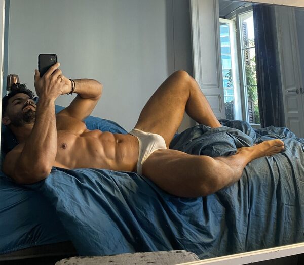 In bed selfie and yes!  What’s under those white briefs looks very promising!