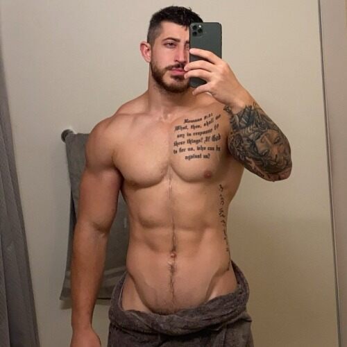 Trimmed beard - tatts - smooth muscle - happy trail - ready to loose his pants.