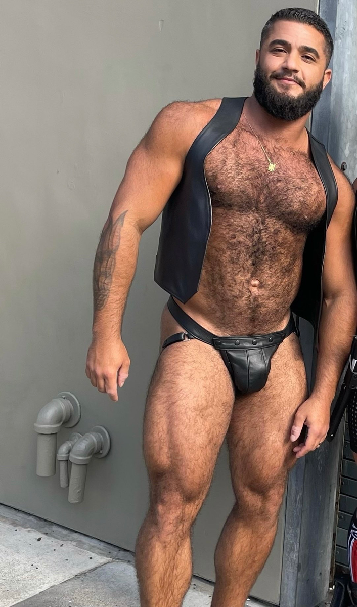 What’s not to like with his hairy chest framed with that black leather vest and leather jock!  Woof!