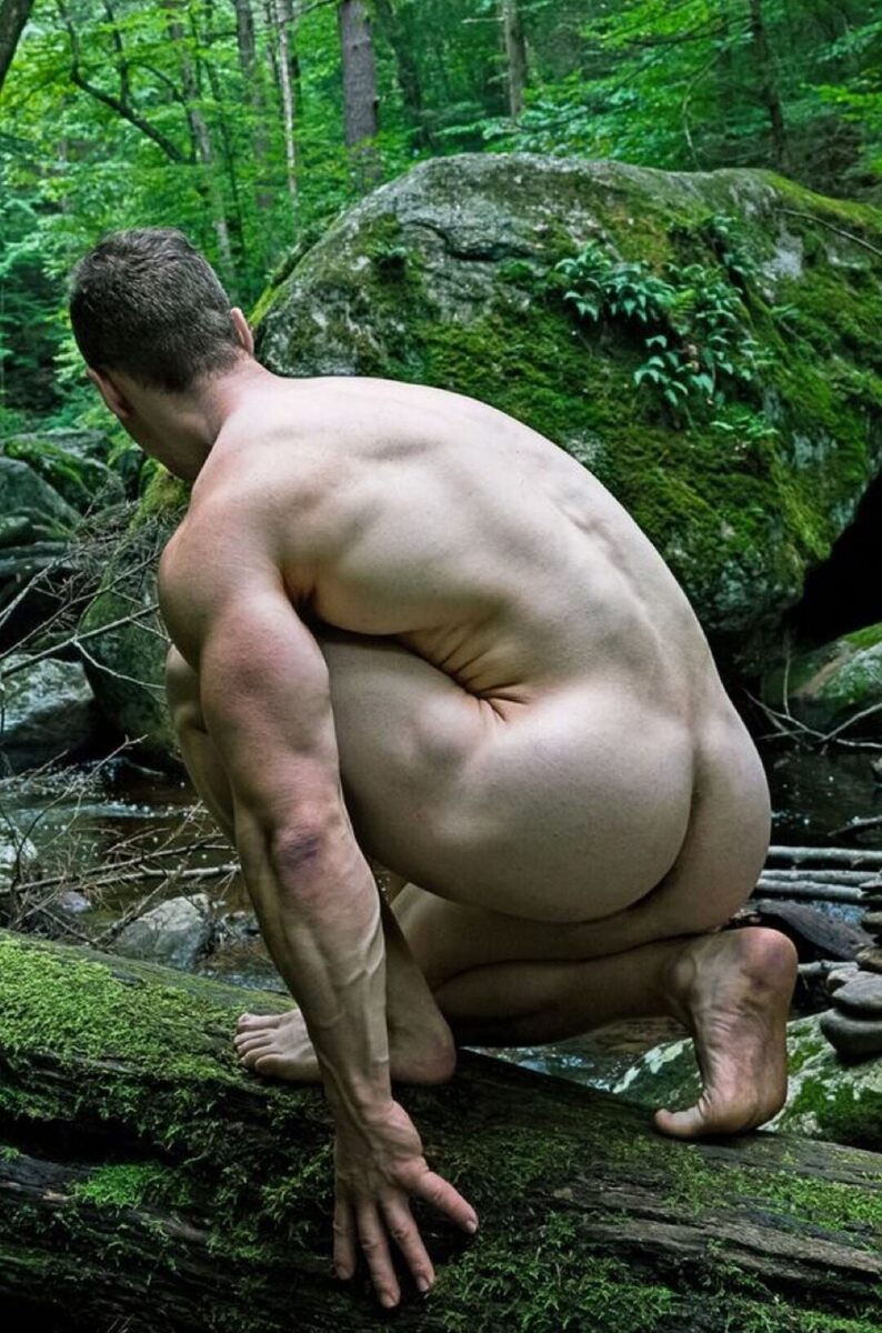 Getting in his knees in the green outdoors.