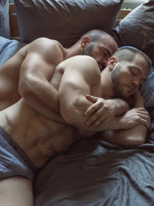 Big muscle couple in a cuddling sleep