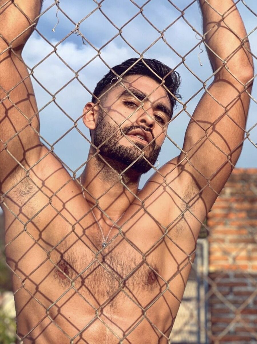 Behind the chain link fence