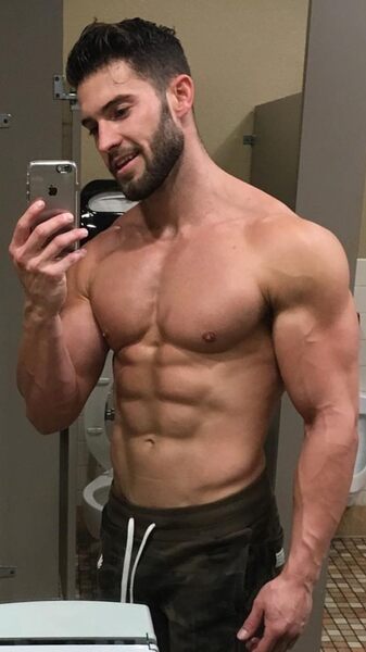 As is typical of so many men’s room selfies… the toilet seat is in the up position…