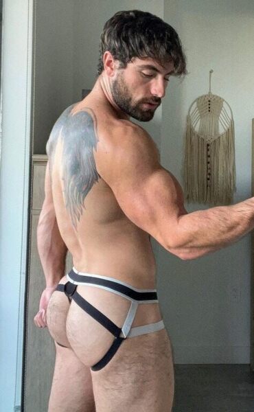 What’s hanging on the wall is almost as interesting as his jockstrap…