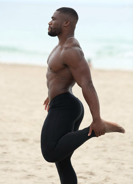The gorgeous Pierre Vuala stretching on the beach