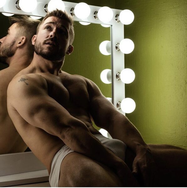 On the counter leaning against the mirror on the wall…
