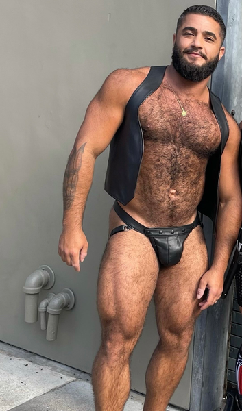 What’s not to like with his hairy chest framed with that black leather vest and leather jock!  Woof!