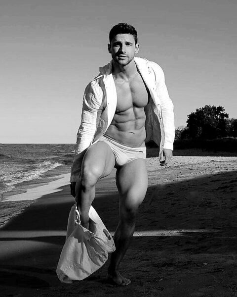 Undressing on the beach… and YES!  The hot thighs complete the package!