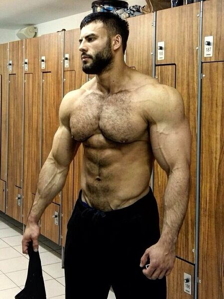 In the locker room waiting for  someone to worship his chest…