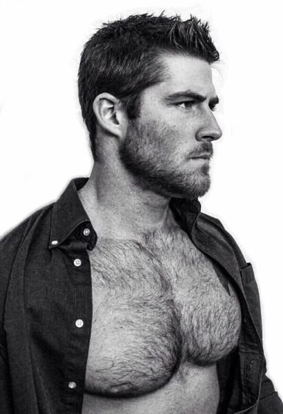 His unbuttoned hairy chest, scruff beard, and look of determination.