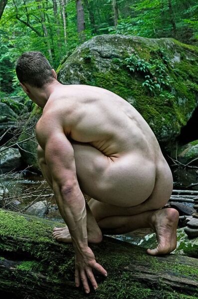 Getting in his knees in the green outdoors.