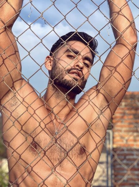 Behind the chain link fence