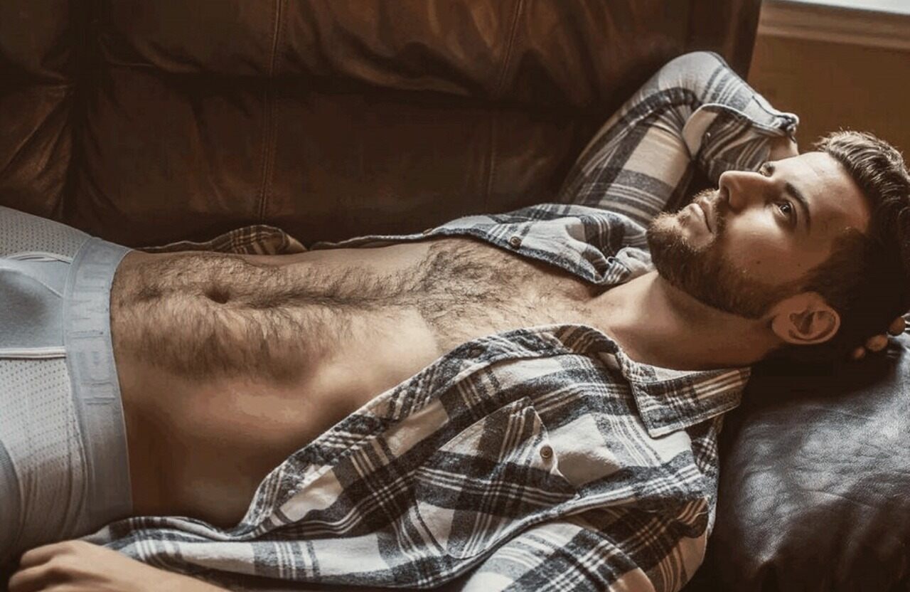 His unbuttoned plaid flannel shirt