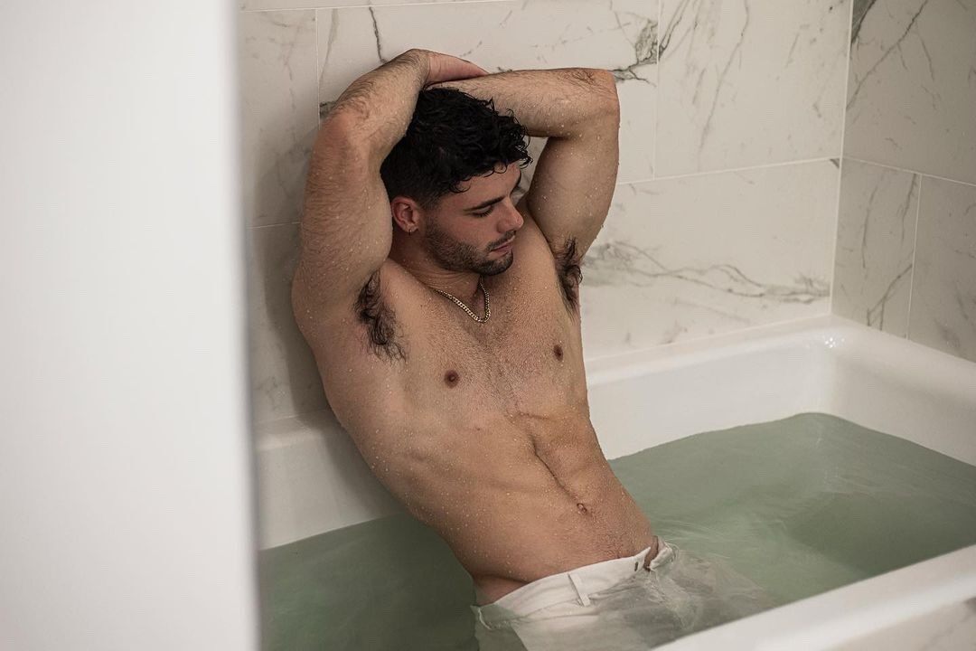 In the tub with his pants on… what ever floats your boat…