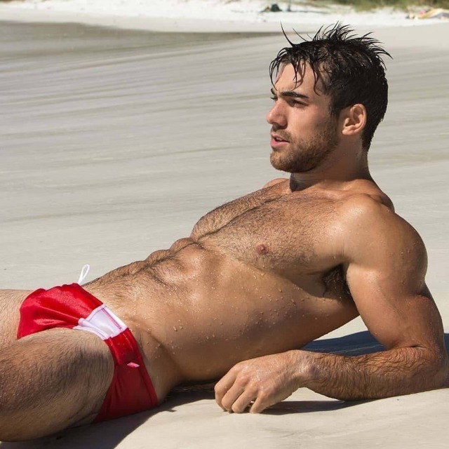 His red Speedo®️and hot abs…