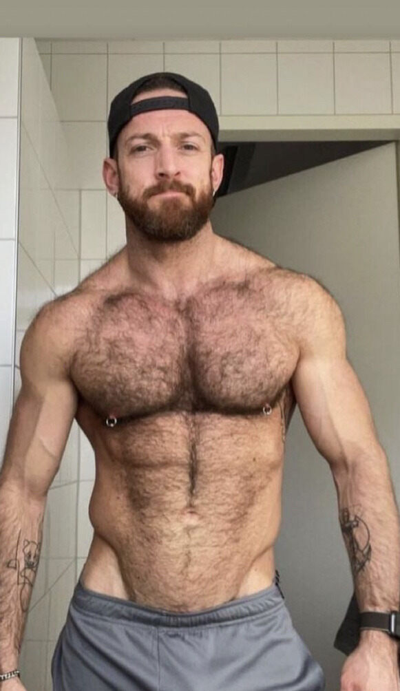 His backward cap and pierced nips…
