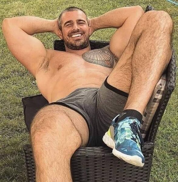 Outdoors in his wicker chair