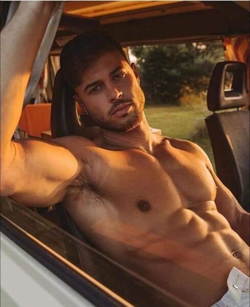 Riding shotgun… shirtless and unzipped…