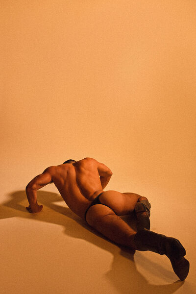 On the floor and wearing that thong quite well!