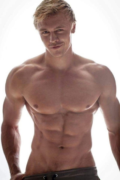 Blondish and taking his shorts off.