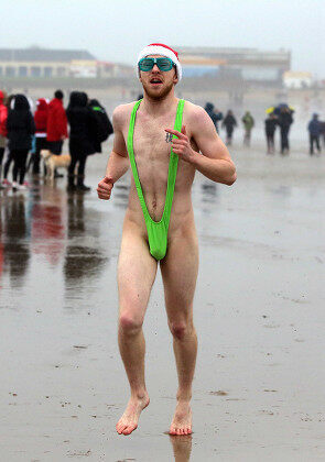 young-man-mankini-runs-towards-sea-440nw-5502028e.jpg